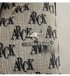 Detail of retro bucket bag with black and white print and silver kangaroo logo