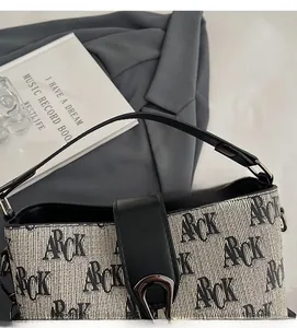 Close-up of retro printed bucket bag showing fabric texture and black leather accents