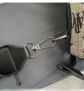 Detail shot of premium gunmetal lobster clasp and vintage pattern on canvas bag