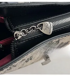 Macro detail of silver metal zipper with smooth puller on a vintage bucket bag