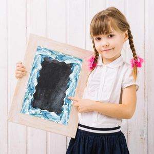 Detail of child holding ocean wave pattern bulletin board border for classroom decoration