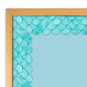 Macro view of teal mermaid scale bulletin board border on a wooden frame edge