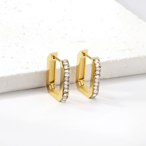 Detail of rectangular gold earrings with pave emerald cut clear zircon on stone