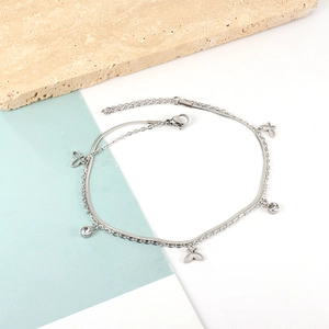 Detail of silver double-layer anklet featuring hollow butterfly charms and round crystals