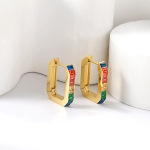 Rectangle gold huggie earrings with rainbow baguette crystals on geometric stone stand