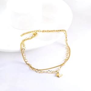 Close-up of double-layer gold butterfly anklet with hollow design and round crystal link