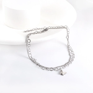 Close-up of double-layer stainless steel anklet featuring hollow butterfly and silver chain