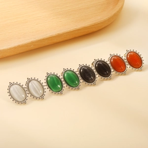 Detailed view of vintage stainless steel rings set with colorful oval cat-eye stones