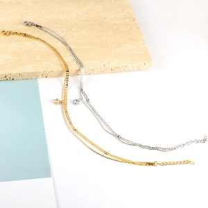 Close-up of double-layer stainless steel anklet with hollow butterfly and zircon stone