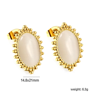 Detail view of oval earrings featuring white cat eye stone and golden beaded border decor