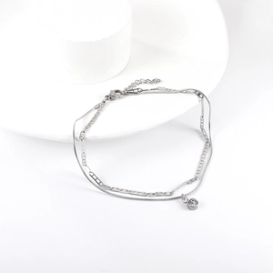 Detail of silver double-layered chain with hollow butterfly links and round cubic zirconia