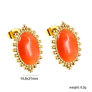 Detail view of oval orange cat eye earrings with gold beaded edges measuring 14.8x21mm