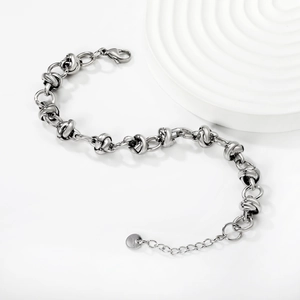 Detail of silver knot chain bracelet featuring lobster clasp and adjustable extension chain