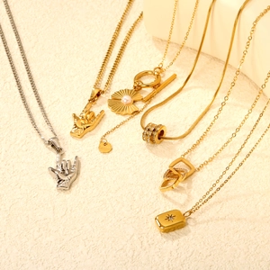 Various stainless steel necklaces featuring pearl and geometric pendants in gold and silver
