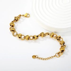 Detail of gold-plated stainless steel link chain bracelet with lobster clasp and tag