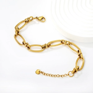 Macro detail of gold stainless steel chunky link bracelet with lobster clasp and chain