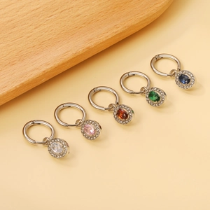 Detail of five oval crystal hoop earrings in assorted colors with stainless steel settings