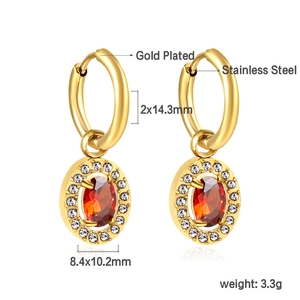 Close-up of gold plated stainless steel hoop earrings with oval ruby and diamond halo