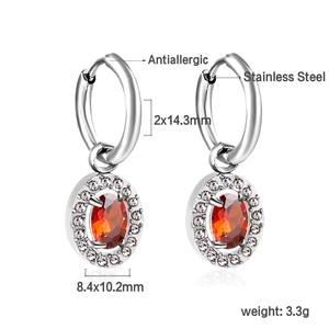 Detail view of stainless steel hoop earrings with oval red stone and crystal halo