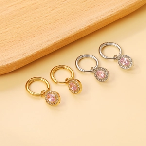 Detail of gold and silver earrings with pink oval stones and micro-pave crystals