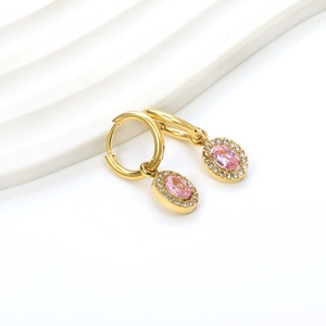Detail of gold circle earrings with an oval pink gemstone and shimmering micro-pavé accents