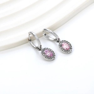 Close-up of silver earrings with oval pink gemstones and sparkling zircon halo