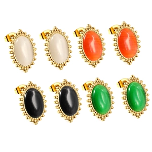 Vintage gold-plated oval stud earrings with white cat eye stone and beaded edge details