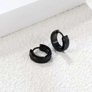 Classic black stainless steel hoop earrings with frosted glitter finish on white background