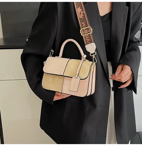 Detail of color-block square bag featuring accordion pleats and printed wide strap
