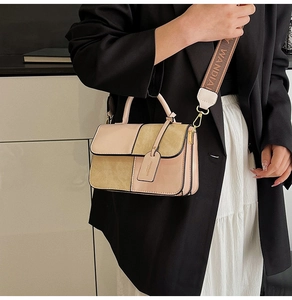 Detail of pink and beige patchwork bag with jacquard fabric strap on a model