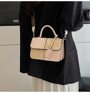 Detail of the pink and beige patchwork shoulder bag with wide woven strap and metal hardware