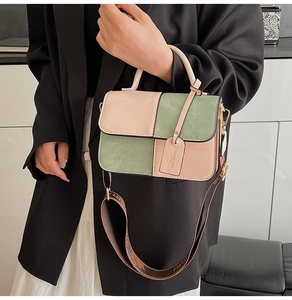 Detail of color-block crossbody bag featuring jacquard strap and leather texture