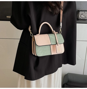 Detail of color-block flap bag showing pink and sage green suede leather texture