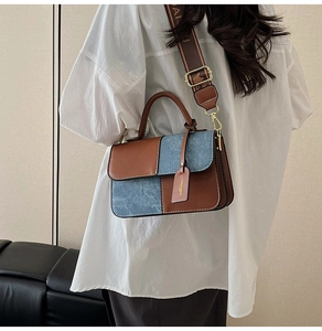 Detail of color-block crossbody bag with denim splicing and wide jacquard strap