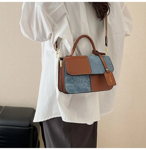 Detail of color-block flap crossbody bag featuring brown leather and blue denim texture