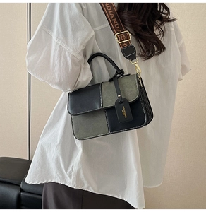 Detail of contrast leather shoulder bag with wide jacquard strap and gold hardware