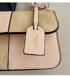 Detail of pink leather and khaki fabric patchwork on crossbody bag with gold hardware