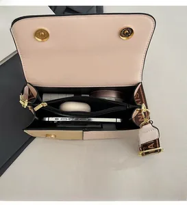 Detail view of the bag interior showing three compartments for phone and cosmetics