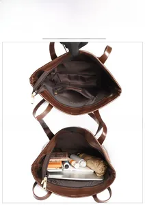 Detailed interior of a brown tote bag showing a zipper pocket and large capacity storage