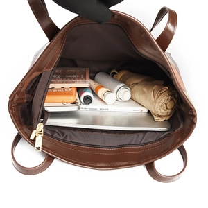 Brown faux leather tote bag with large capacity showing interior storage space and pockets