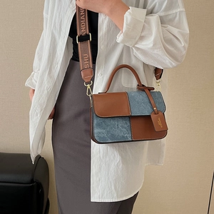 Modern color-block square crossbody bag in brown leather and blue denim with wide strap