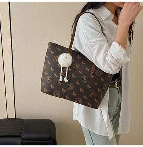 Brown vintage tote bag with horse monogram pattern and white plush donkey charm accessory