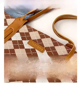Detailed close-up of brown and white checkered woven fabric with premium leather strap