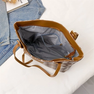 Top view of quilted tote bag showing spacious grey interior and internal zipper pocket