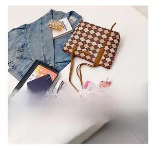 Flat lay of large checkered tote bag showing spacious internal capacity for daily essentials