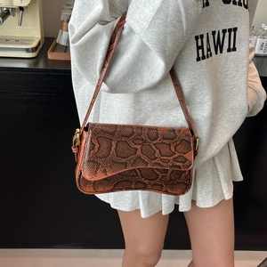 Retro brown snake pattern shoulder bag with a curved base and flap closure for women