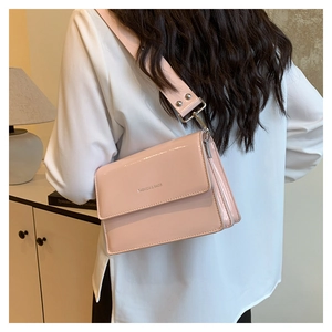 Close-up of pink patent leather handbag featuring Fashion & Bags silver lettering