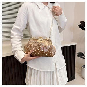 Detail of velvet pearl shell bag with butterfly embroidery and elegant pearl chain strap