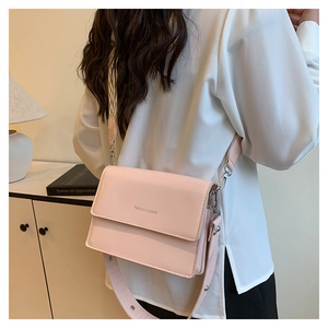 Pink glossy patent leather crossbody square bag with metallic buckle and shoulder strap