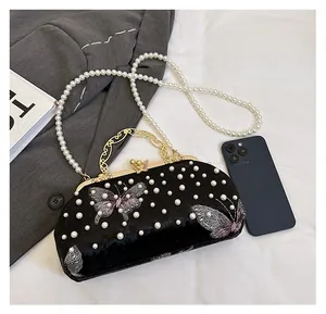 Size comparison of black velvet shell bag with butterfly embroidery and pearl chain